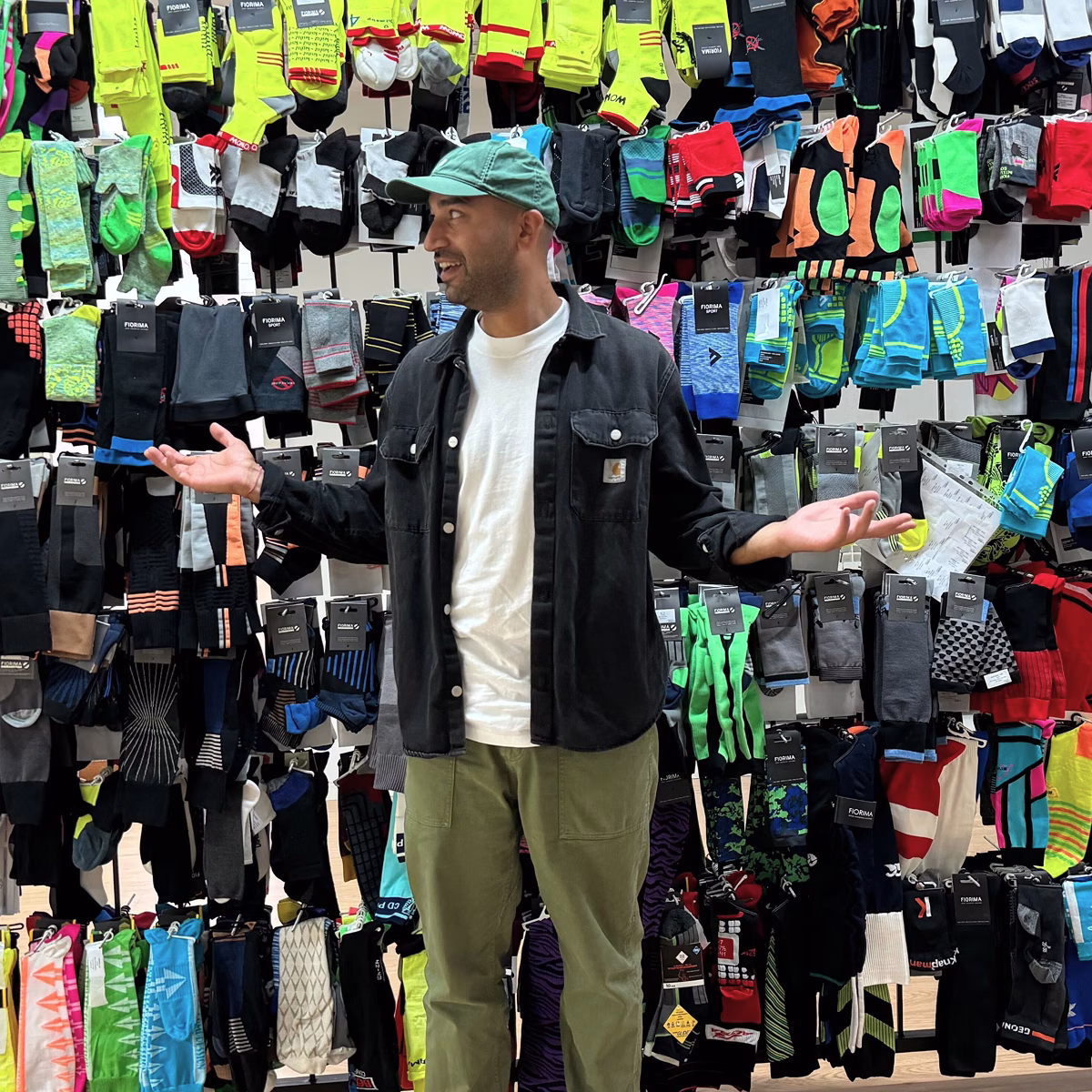 HighCohesion Co-founder Aran infront of a display of socks