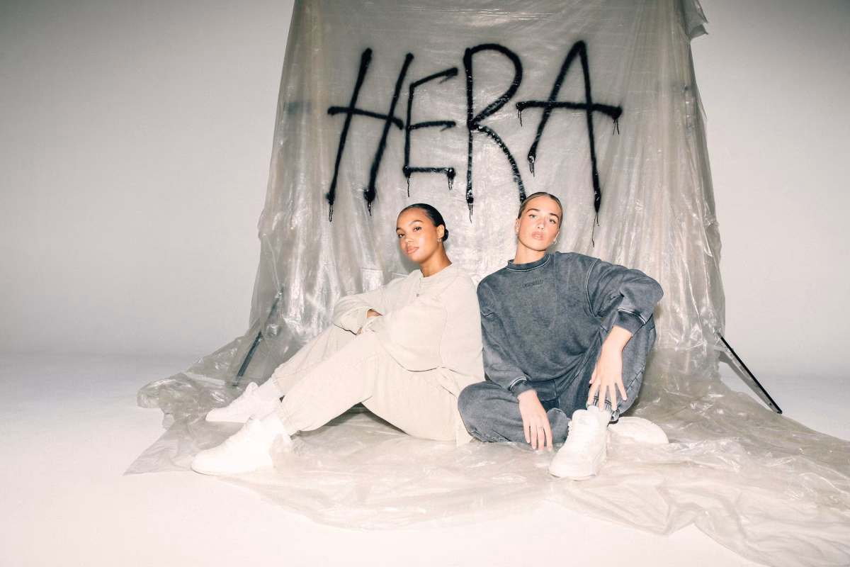 HERA models infront of a HERA sign